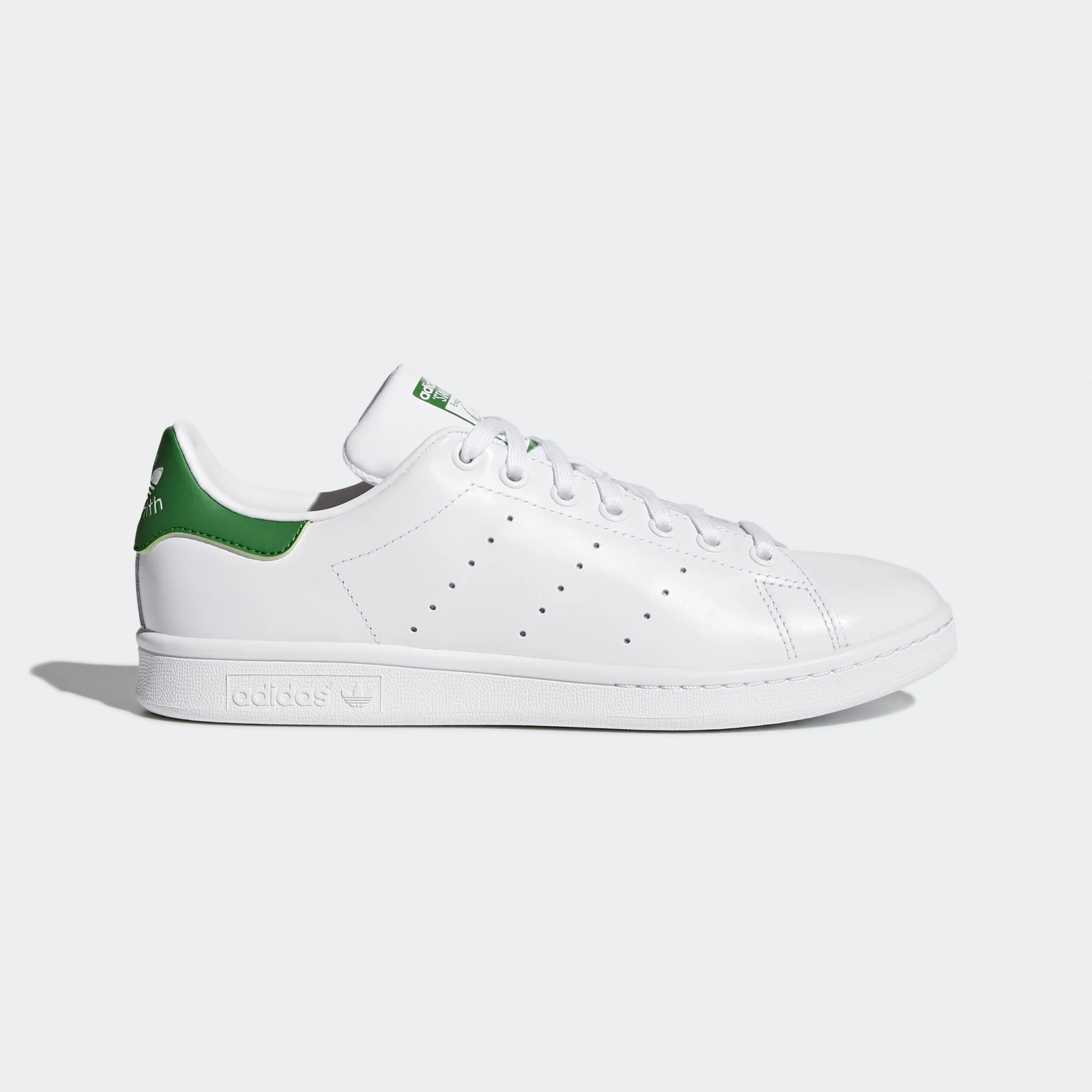 Adidas Stan Smith in white leather with green heel tab — side profile showing perforated 3-Stripes
